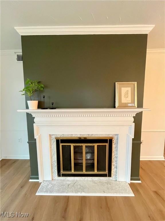 details featuring ornamental molding and a premium fireplace