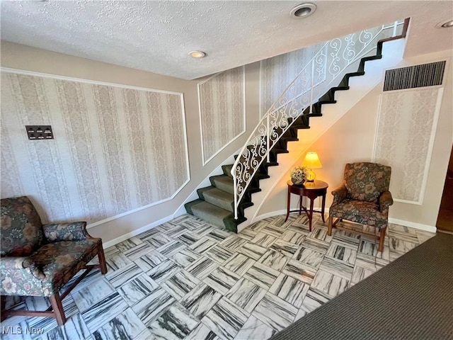 sitting room with a textured ceiling