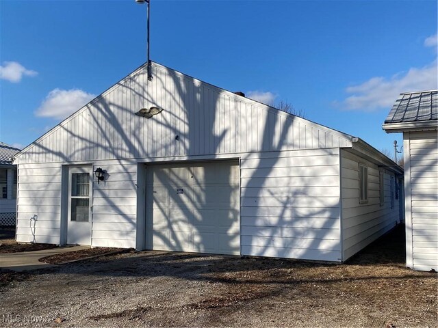 rear view of property with a garage