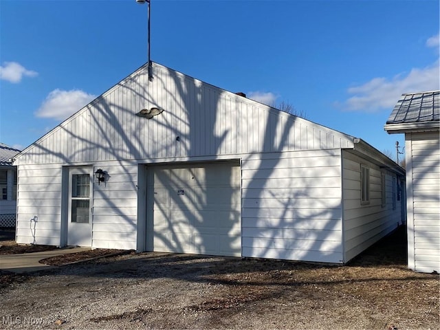 exterior space with an outdoor structure and dirt driveway