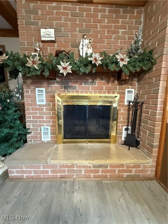 room details featuring hardwood / wood-style flooring and a fireplace