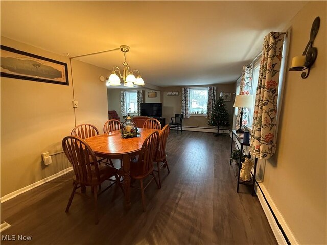 dining space with a baseboard radiator, dark hardwood / wood-style floors, and a chandelier