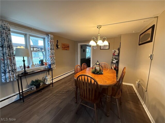 dining room with dark wood-type flooring, a chandelier, and a baseboard radiator