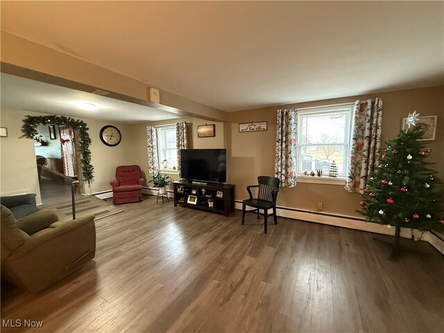 living room featuring wood-type flooring and a baseboard radiator