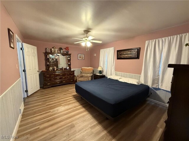 bedroom with ceiling fan and light hardwood / wood-style floors