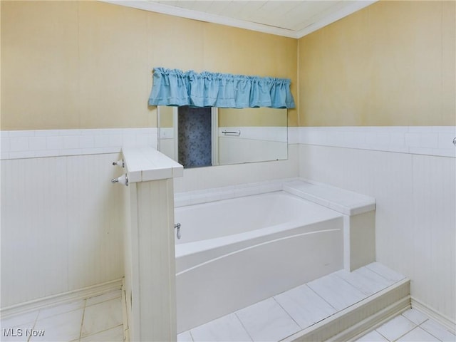 bathroom with a bathing tub and ornamental molding