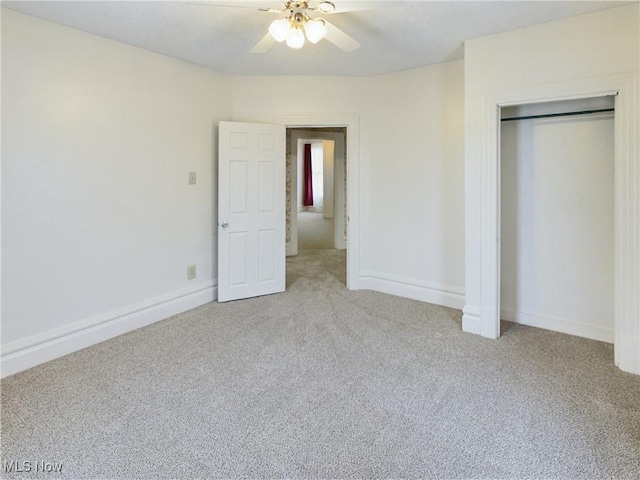 unfurnished bedroom featuring light carpet, ceiling fan, and a closet