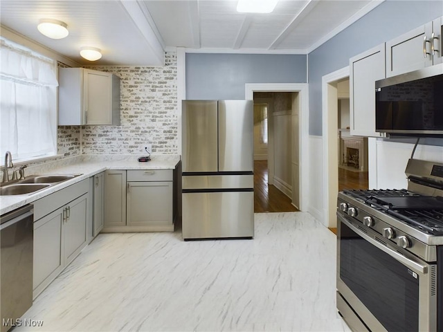 kitchen with stainless steel appliances, gray cabinets, and sink