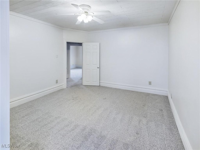 carpeted empty room with crown molding and ceiling fan