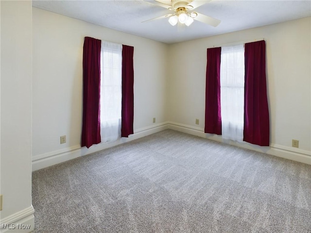 carpeted spare room with ceiling fan