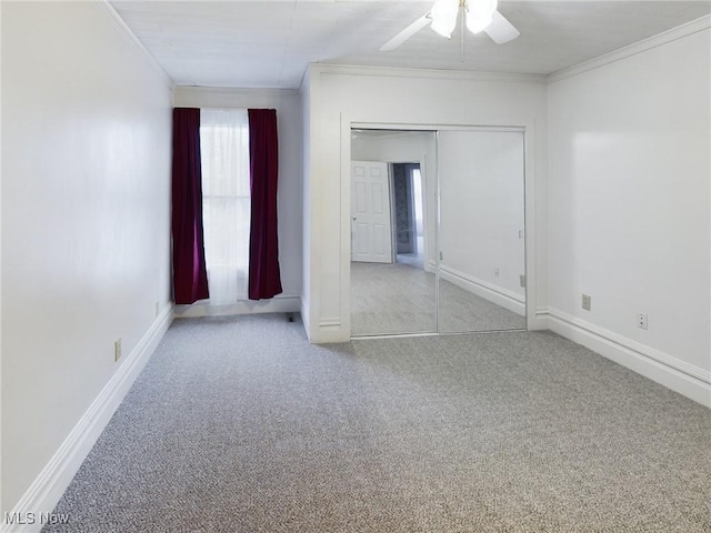 carpeted empty room featuring crown molding and ceiling fan