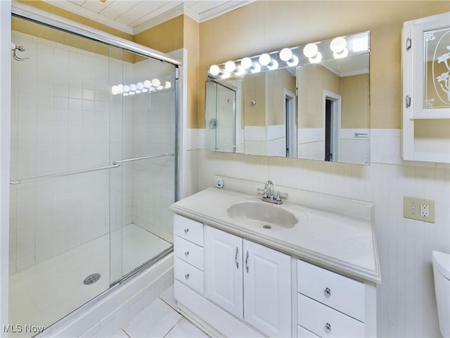 bathroom featuring vanity, an enclosed shower, crown molding, and toilet