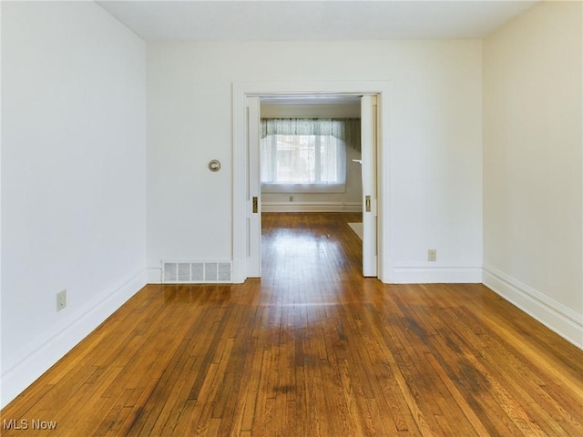 spare room with dark hardwood / wood-style flooring