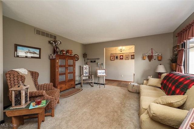 living area with carpet floors and visible vents