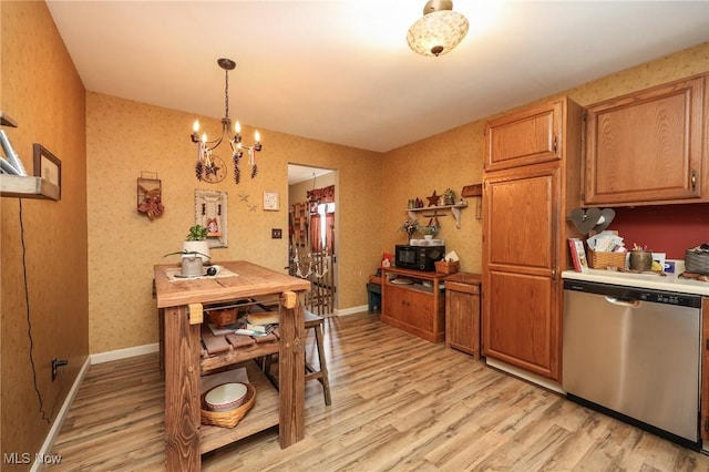 interior space with light wood-style flooring, pendant lighting, stainless steel dishwasher, and light countertops