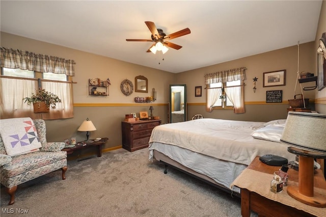 bedroom featuring light carpet, ceiling fan, and baseboards