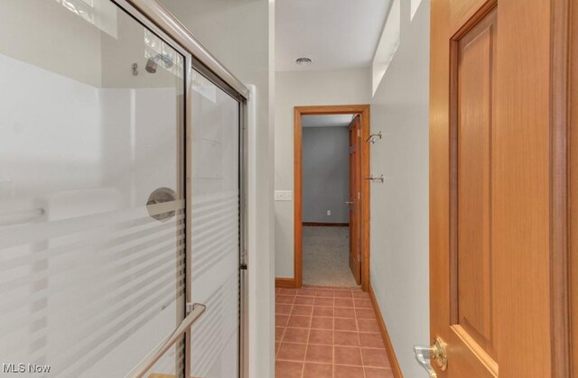 hallway with light tile patterned floors