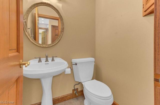 bathroom featuring tile patterned flooring and toilet