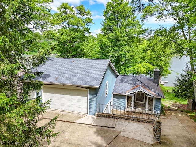 466 W Mohawk Dr, Malvern, OH 44644 - view of front of home featuring concrete driveway, a shingled roof, a chimney, and a garage