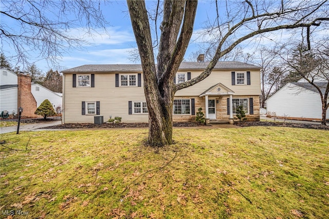 view of front of house featuring a front lawn and central air condition unit