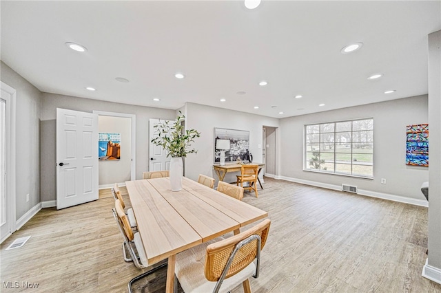 dining space with light wood-type flooring