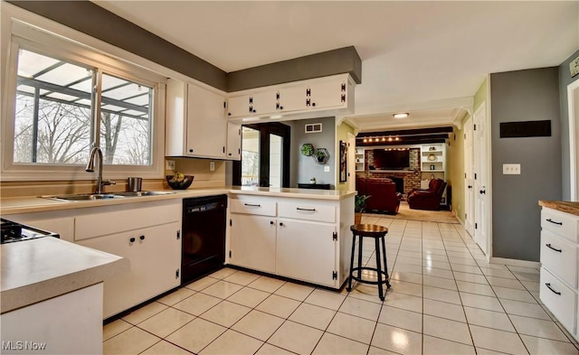 kitchen featuring sink, light tile patterned floors, dishwasher, white cabinets, and kitchen peninsula