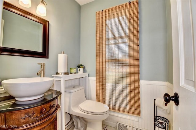 bathroom featuring vanity, toilet, and tile patterned flooring