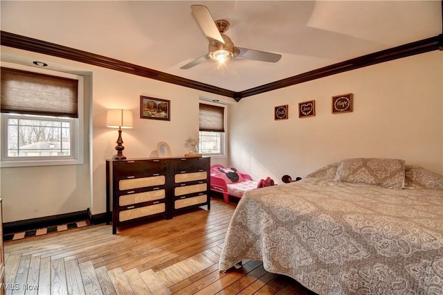 bedroom featuring hardwood / wood-style flooring, ornamental molding, and ceiling fan