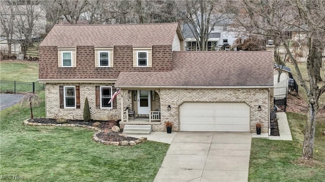 view of front of house featuring a garage and a front lawn