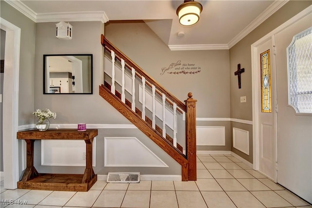 foyer featuring ornamental molding and light tile patterned floors