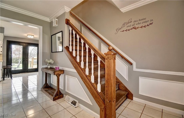 staircase with french doors, tile patterned floors, and ornamental molding