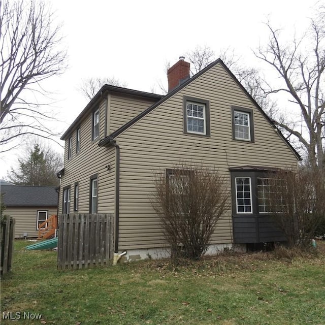 view of side of home featuring a lawn