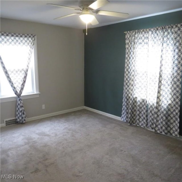 empty room featuring ceiling fan and carpet flooring