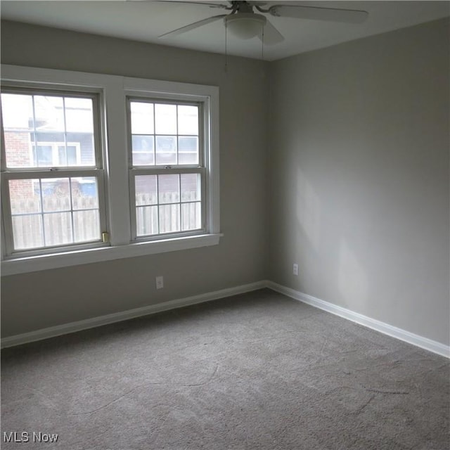 unfurnished room with plenty of natural light, light colored carpet, and ceiling fan