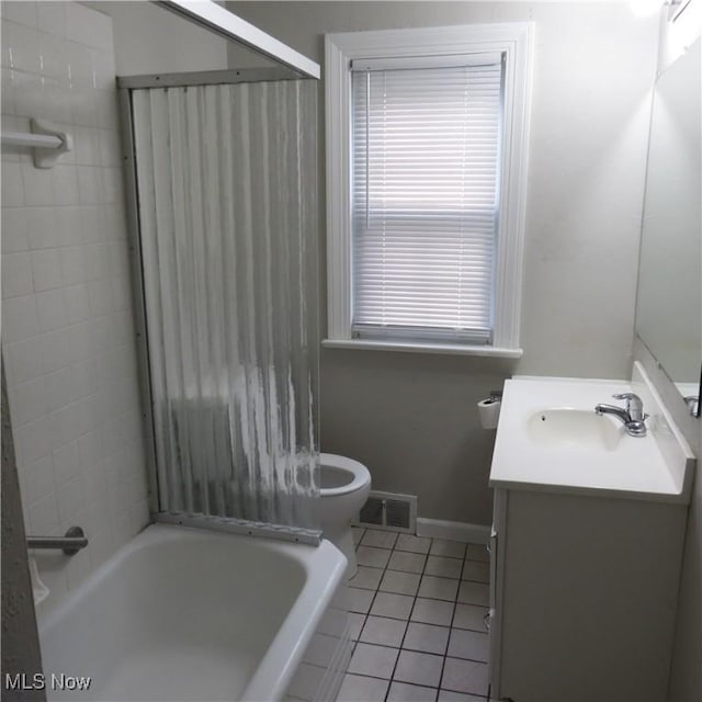 bathroom with tile patterned flooring, vanity, and toilet