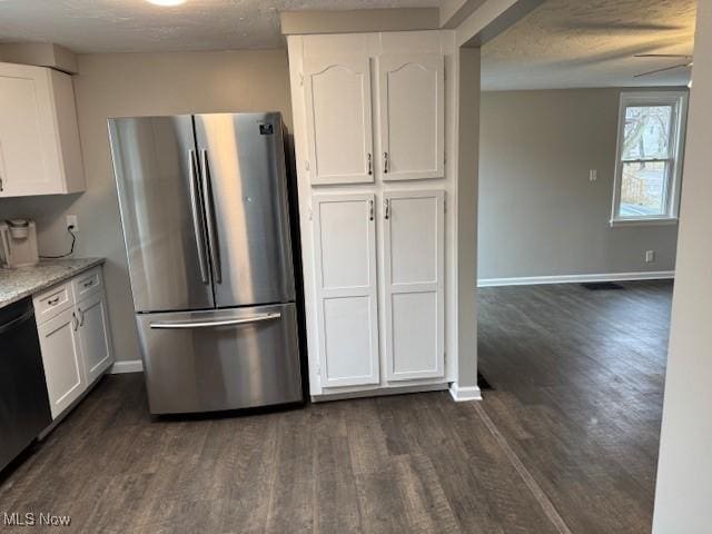 kitchen featuring stainless steel refrigerator, dishwasher, dark wood-type flooring, and white cabinets