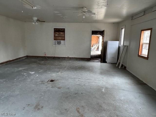 empty room with cooling unit, ceiling fan, and concrete flooring