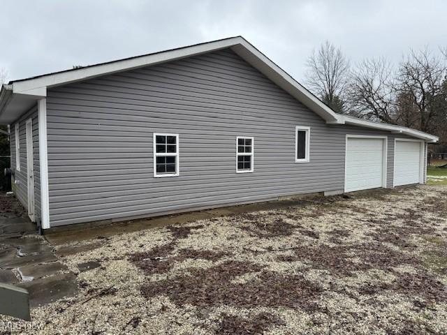 view of side of property with a garage