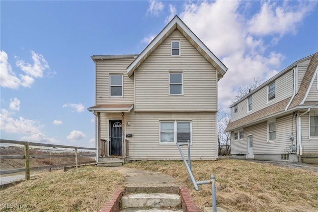 view of property featuring a front lawn