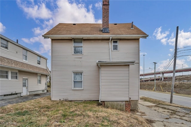 rear view of property featuring a yard