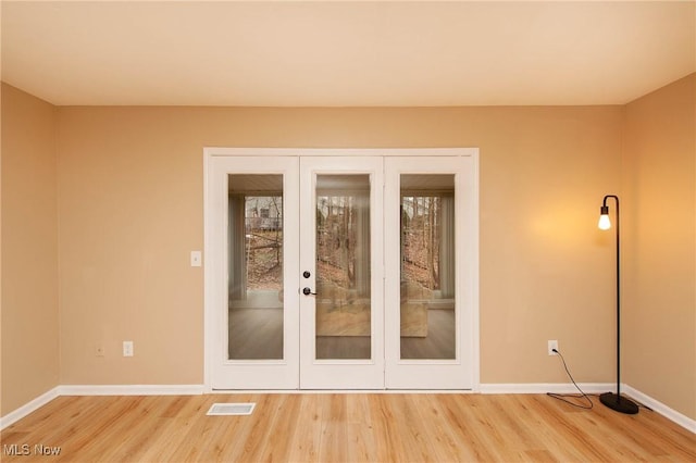 doorway to outside with french doors and hardwood / wood-style floors