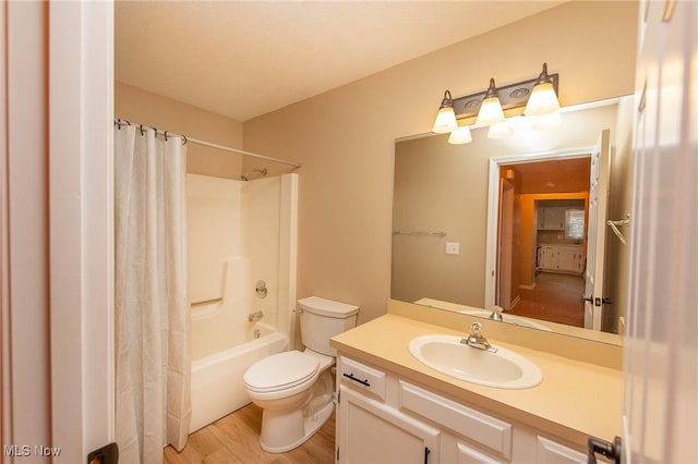 full bathroom with vanity, hardwood / wood-style floors, toilet, and shower / bath combo with shower curtain