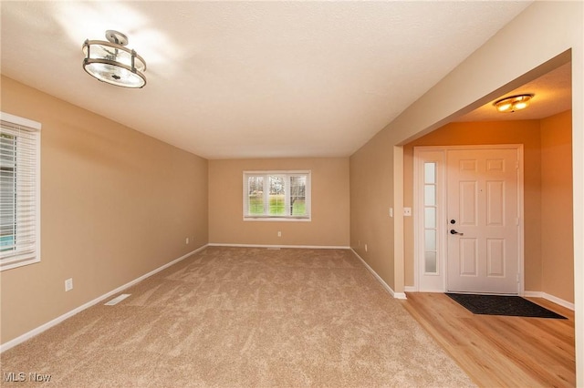 view of carpeted foyer