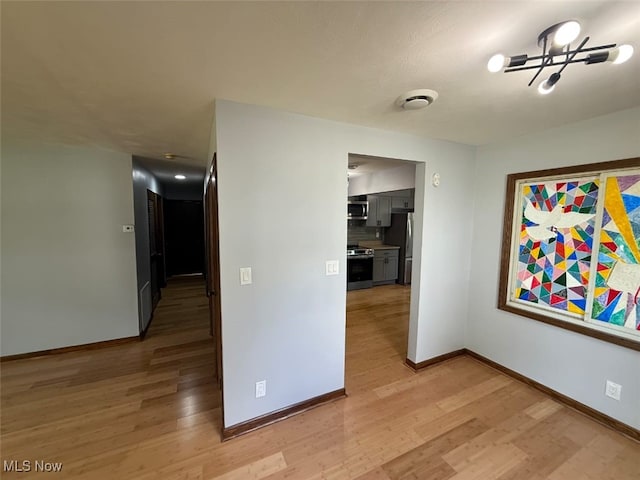 950 Donmar Ln, Boardman, OH 44511 - hallway with light wood-style floors and a chandelier