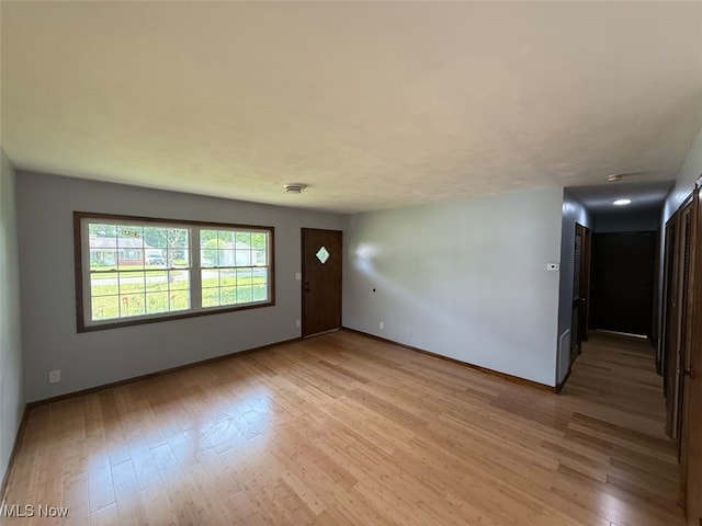 950 Donmar Ln, Boardman, OH 44511 - unfurnished living room with light wood finished floors and baseboards