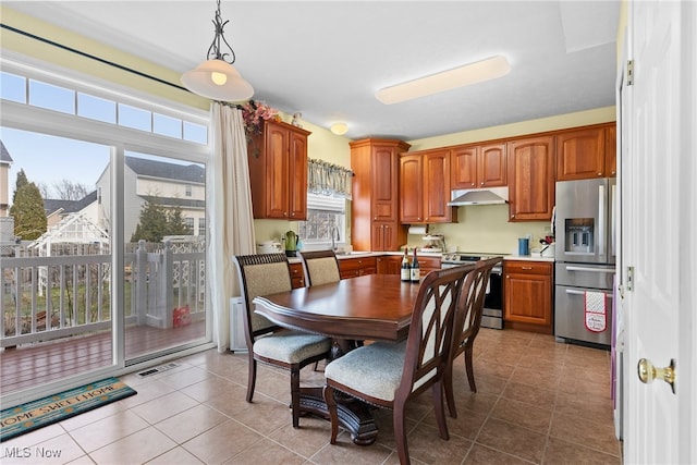 dining area featuring tile patterned flooring and sink