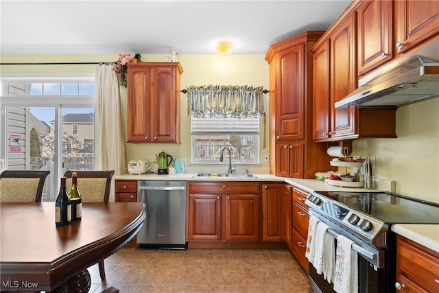 kitchen featuring stainless steel appliances, light tile patterned flooring, and sink