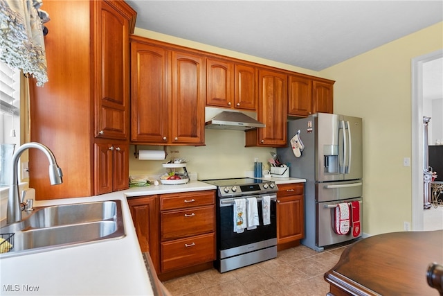 kitchen featuring appliances with stainless steel finishes, sink, and light tile patterned floors