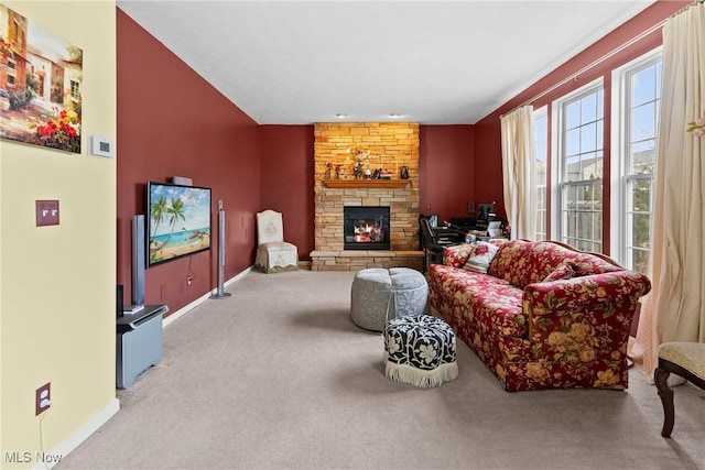 living room with a stone fireplace and light carpet