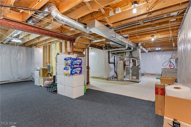 basement featuring heating unit, carpet, and water heater